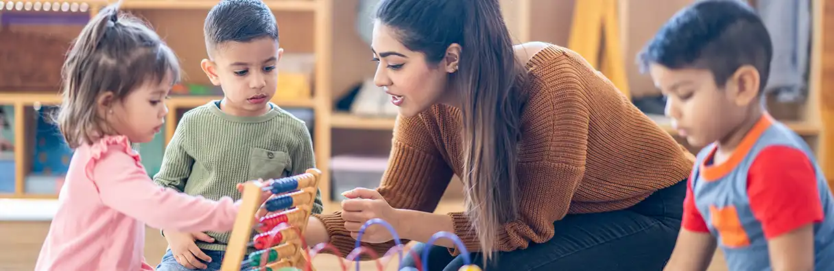 Nursery teacher with children